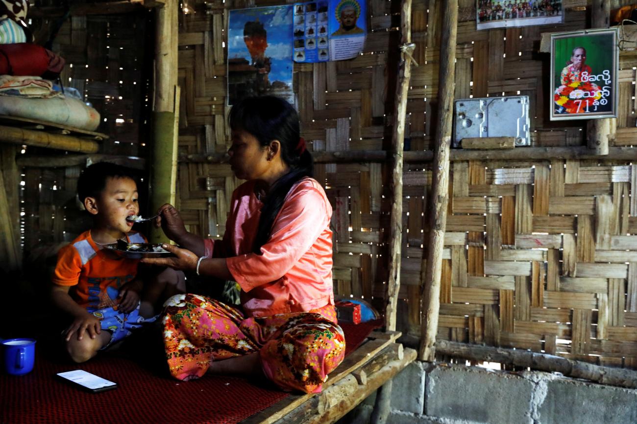 Yin Yin Aye, daughter of Pe Kha Lau, who passed away after U.S. aid cuts led to the closure of health services in Umpiem Mai Refugee Camp, feeds her son, in Phop Phra, Thailand, on February 7, 2025. 