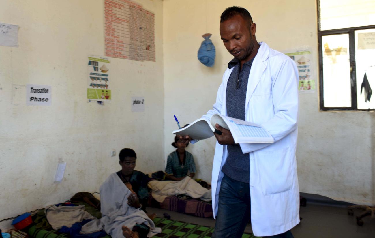 Mulugeta Kassaw, a public health officer, checks the records of malnourished children in Seriel health center in Ethiopia's northern Amhara region, on February 13, 2016.