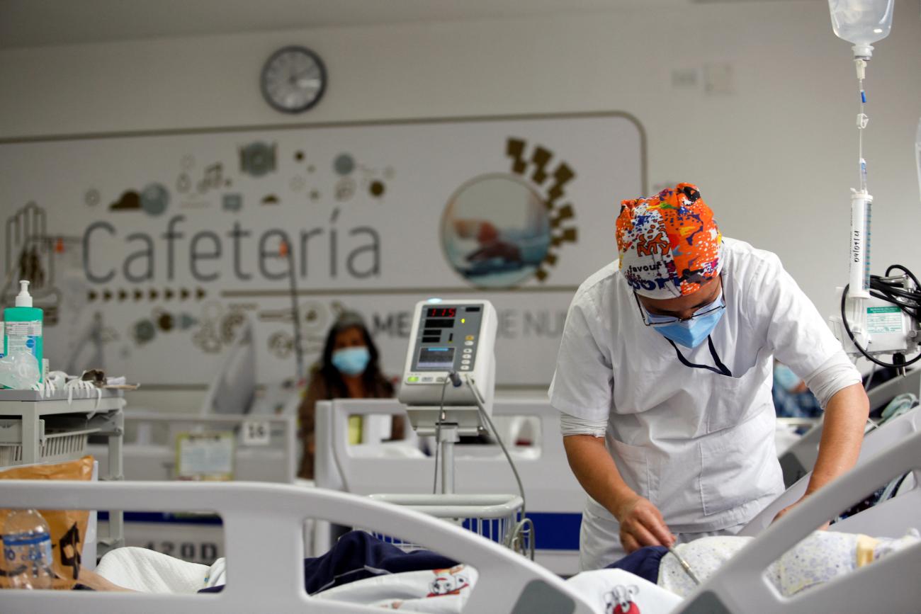 A patient suffering from COVID-19 receives medical attention at the Quito South Social Security Institute dining hall, in Quito, Ecuador, on April 9, 2021. 