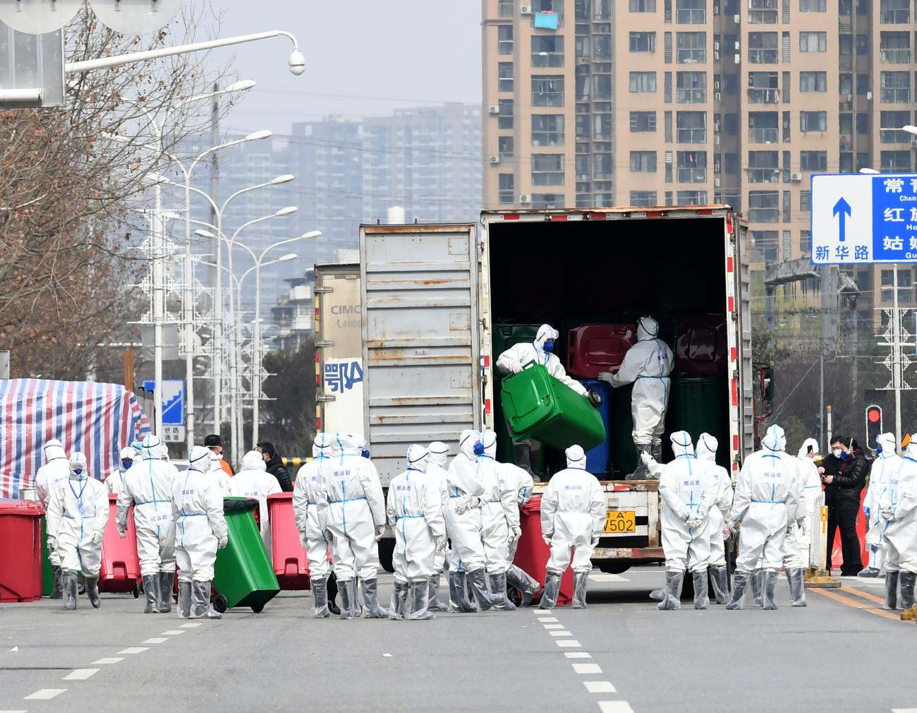 Workers in protective suits take part in the disinfection of Huanan seafood market, where the novel coronavirus is believed to have first surfaced, in Wuhan, Hubei province, China, on March 4, 2020. 