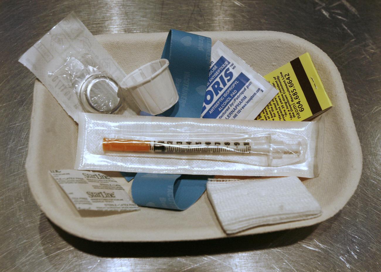 A small kit of supplies containing syringes, bandaids and antiseptic pads waits to be used inside a safe injection site, in Vancouver, British Columbia, Canada, on August 23, 2006. 