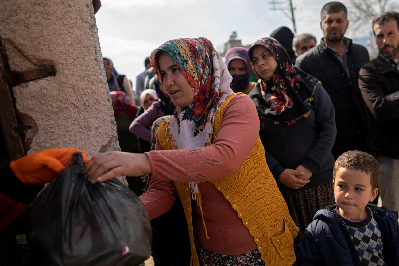 People affected by the deadly earthquake receive aid, in Hatay, Turkey, on February 24, 2023. 