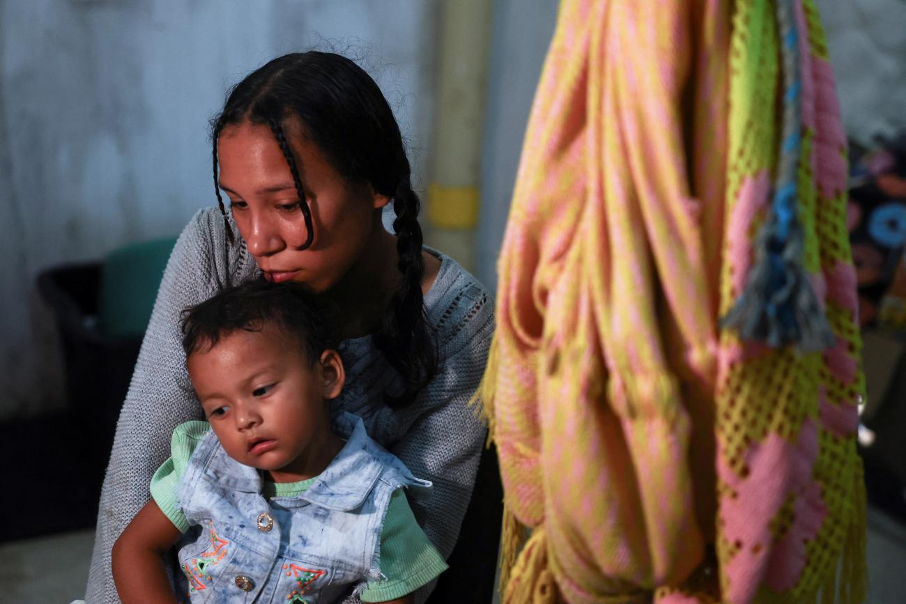 A Venezuelan migrant attends an interview with Reuters accompanied by her daughter, in Riohacha, Colombia, on December 2, 2024.