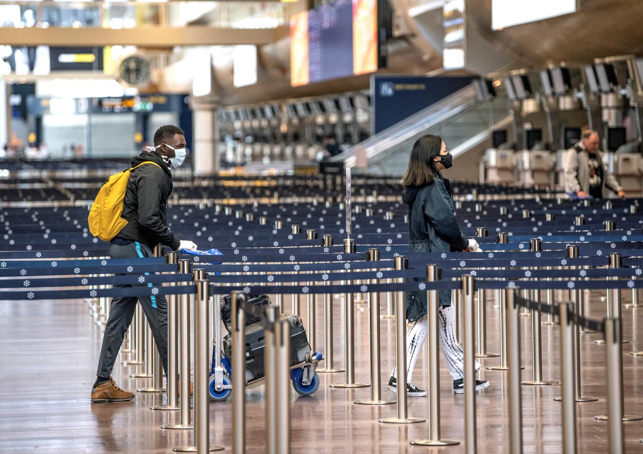 Passengers are pictured wearing protective masks at the Arlanda airport, in Stockholm, Sweden, on April 9, 2020.