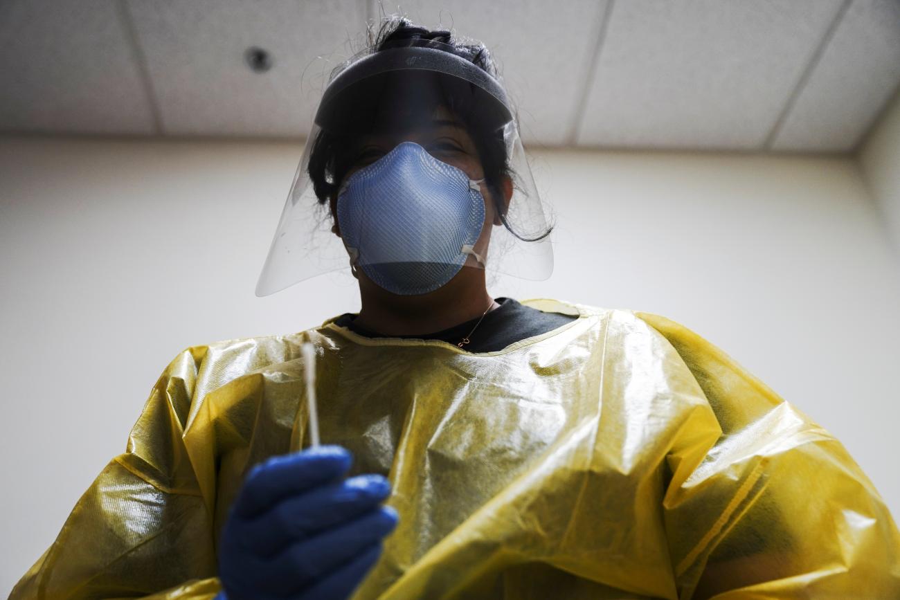 A COVID-19 response specialist prepares to administer a nasal swab test at Public Health Madison & Dane County, in Madison, Wisconsin, on October 19, 2020.