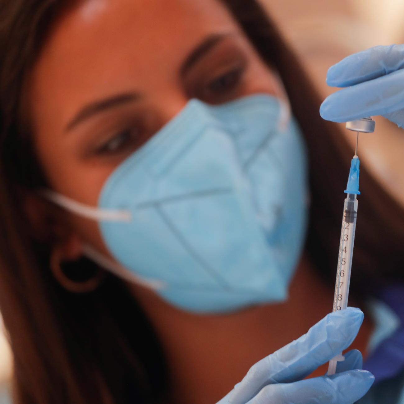 A healthcare worker prepares a dose of the "Comirnaty" Pfizer BioNTech COVID-19 vaccine against the coronavirus disease (COVID-19) at a vaccination centre in Ronda, Spain