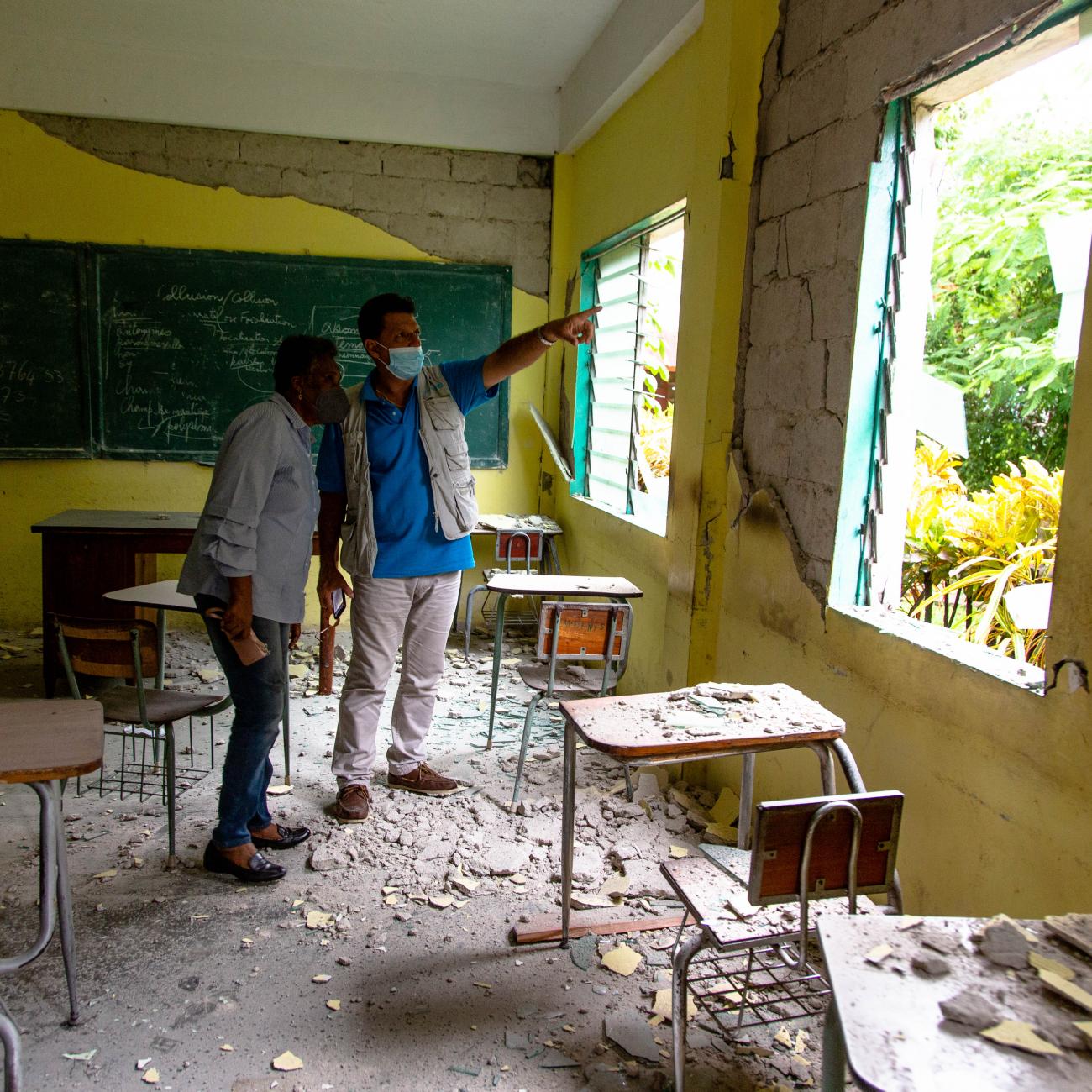 UNICEF's Bruno Maes and Haiti Minister of Education Marie Lucie Joseph tour earthquake damage at the College Mazenod in Camp-Perrin, Les Cayes, Haiti, on August 17, 2021.