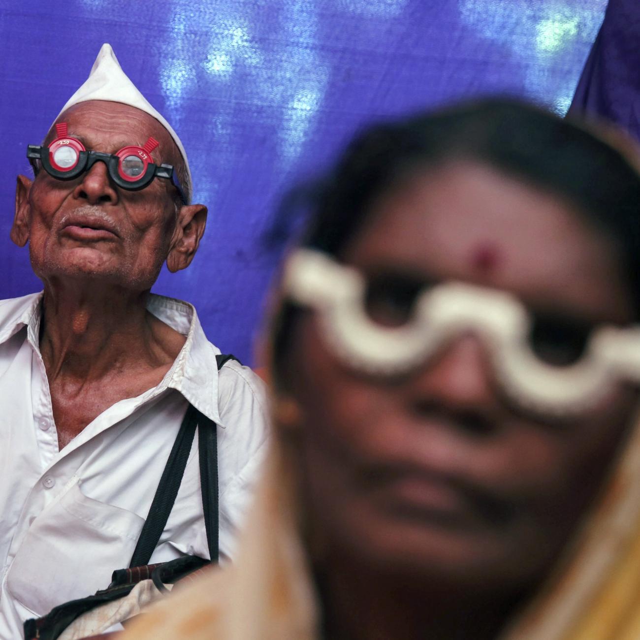 People get their eyes tested at a free eye-care camp, in Mumbai, India, on December 6, 2014.