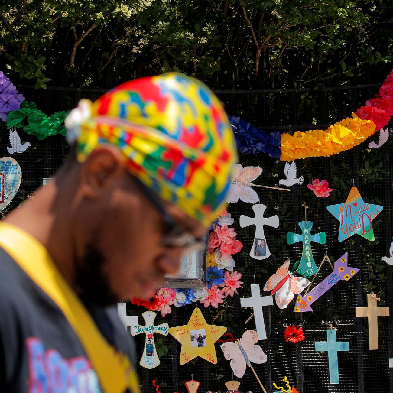 A man passes a "Naming the Lost Memorials” site—memorials curated by artists and activists in memory of those who’ve died of COVID-19, at The Green-Wood Cemetery in Brooklyn, New York, on June 10, 2021.