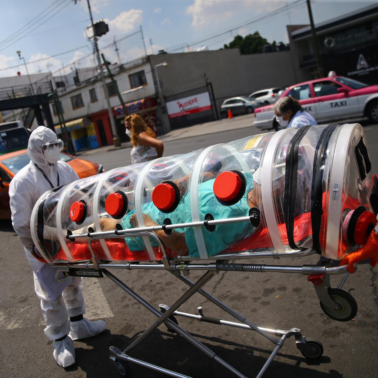 A patient suffering from COVID-19 and diabetes, is pictured inside a capsule as Red Cross paramedics transfer him from a hospital to another in Mexico City, Mexico, on June 8, 2020