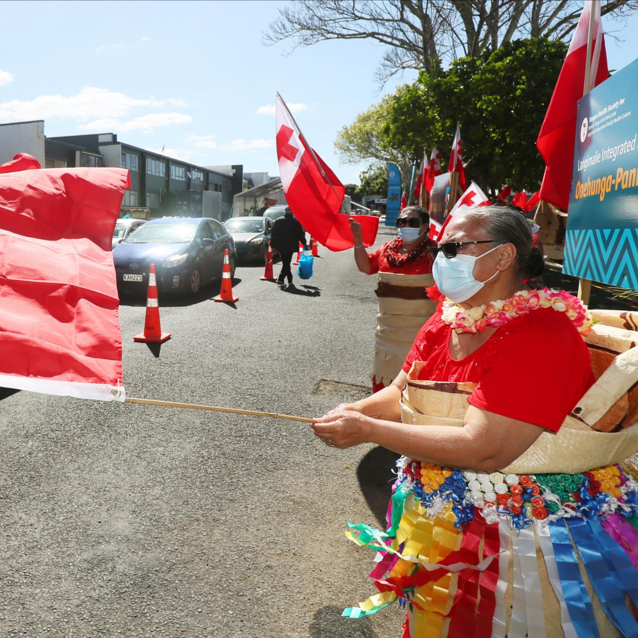 Members of the Tongan community dance at a drive-through coronavirus disease (COVID-19) vaccination clinic in Onehunga during a single-day vaccination drive, aimed at significantly increasing the percentage of vaccinated people in the country, in Auckland, New Zealand, October 16, 2021.