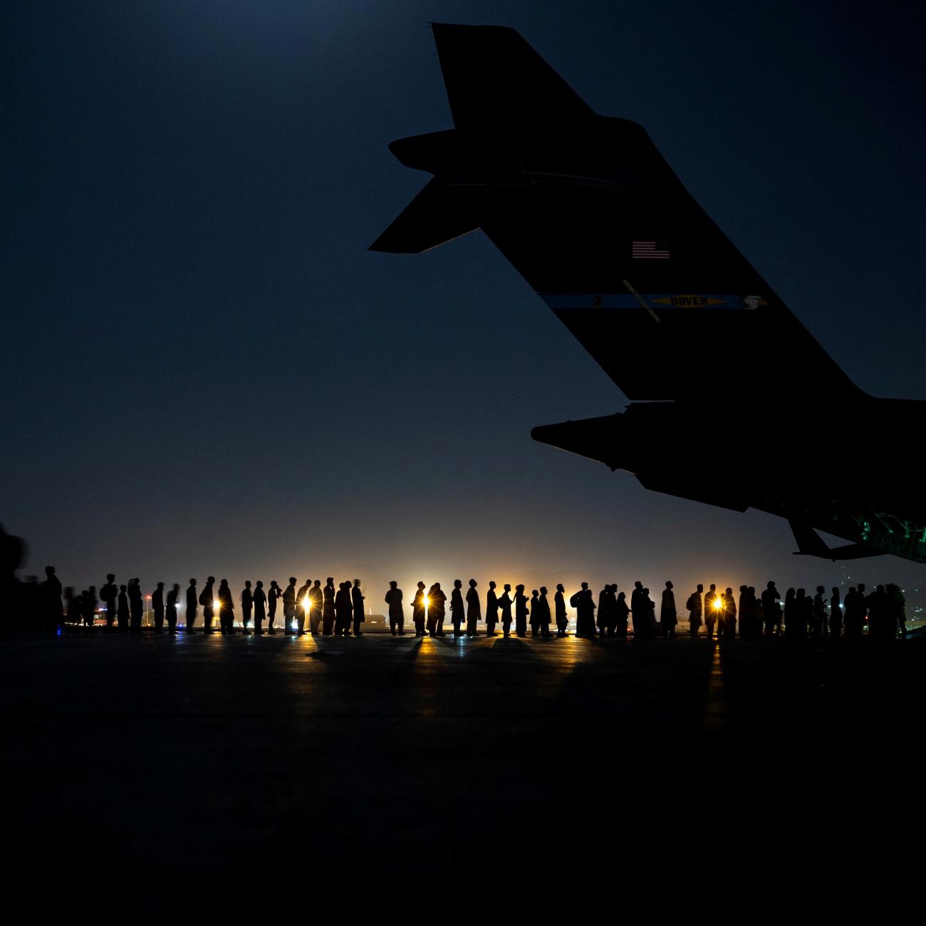 U.S. Air Force aircrew prepare evacuees to board a C-17 Globemaster III aircraft in support of the Afghanistan evacuation at Hamid Karzai International Airport, Afghanistan, on August 21, 2021. 
