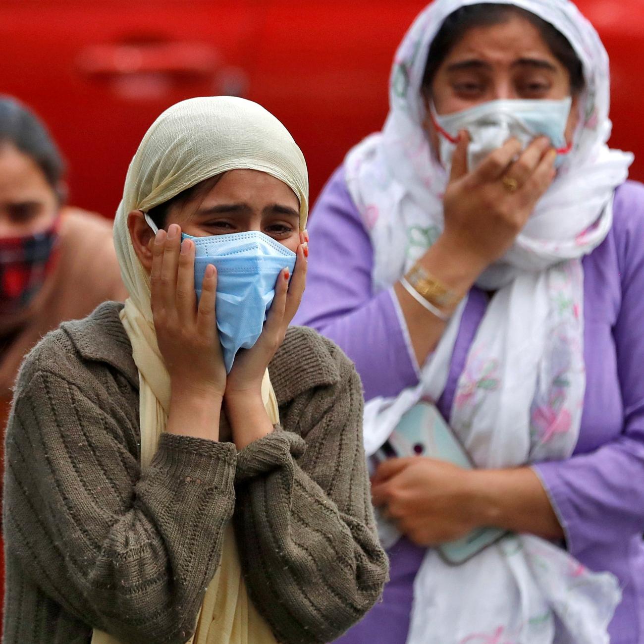Relatives of a man who died from the coronavirus disease (COVID-19) mourn during his cremation at a crematorium ground in Srinagar May 25, 2021.