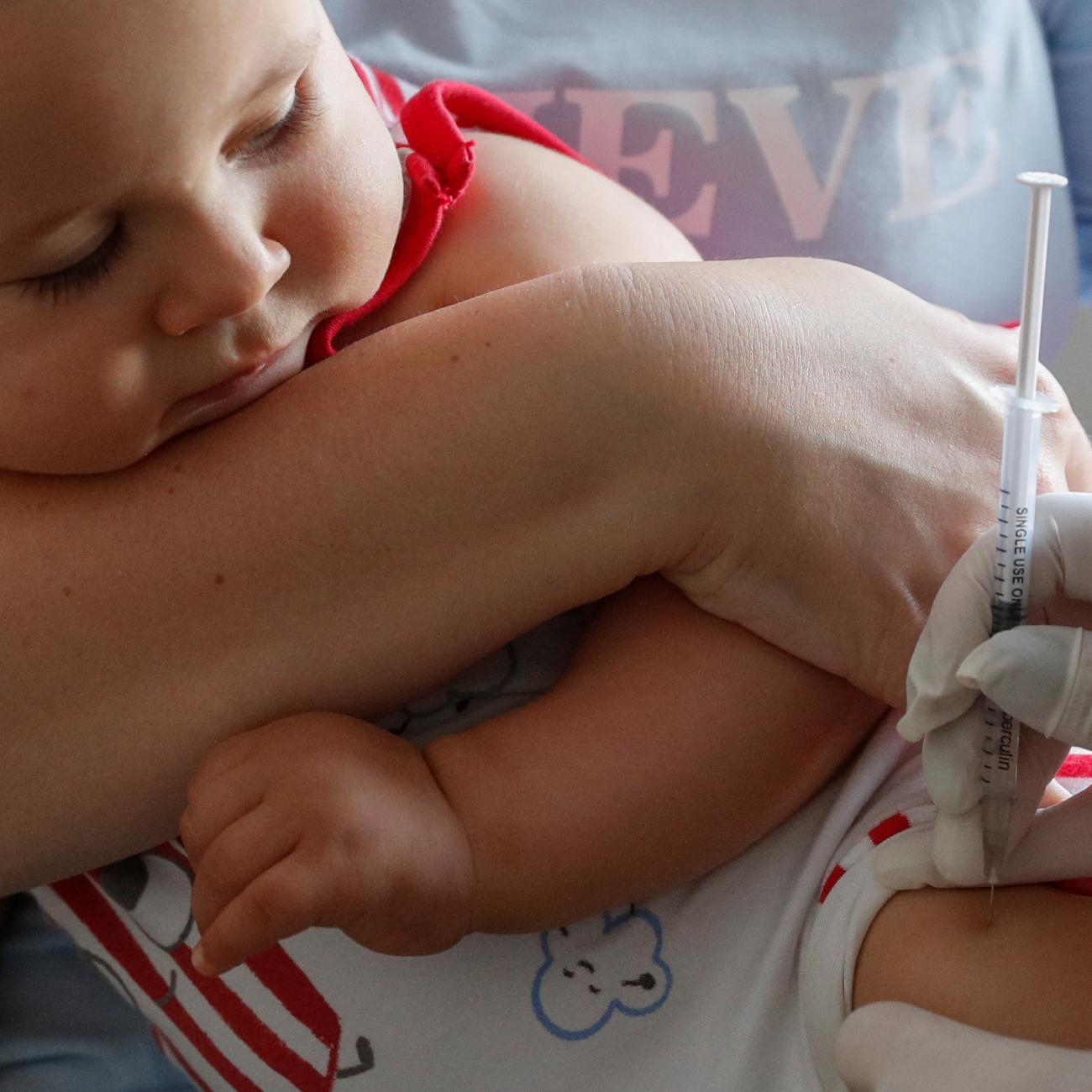 A baby receives a vaccine injection at a children's clinic in Kiev, Ukraine, on August 14, 2019.  Photo by REUTERS/Valentyn Ogirenko