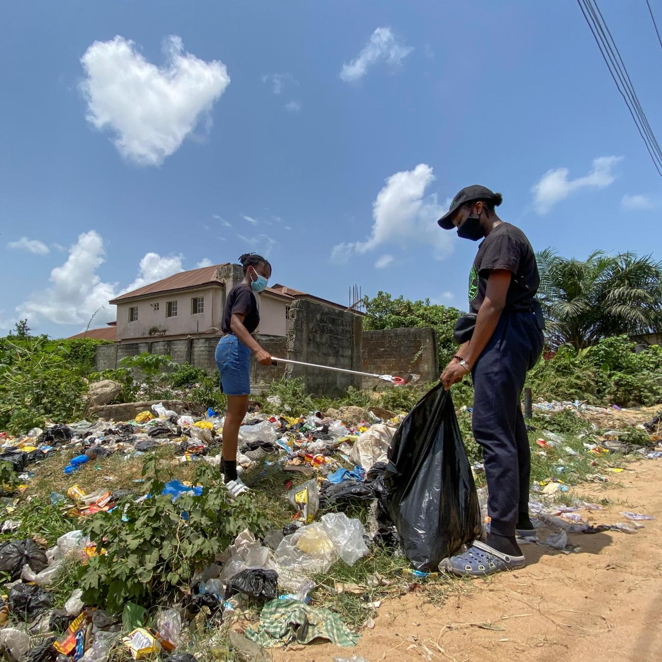 Esohe Ozigbo, a 15-year-old climate change activist, is seen during one of her campaign picking up refuse disposed carelessly in Lagos, Nigeria April 16, 2021. Picture taken April 16, 2021