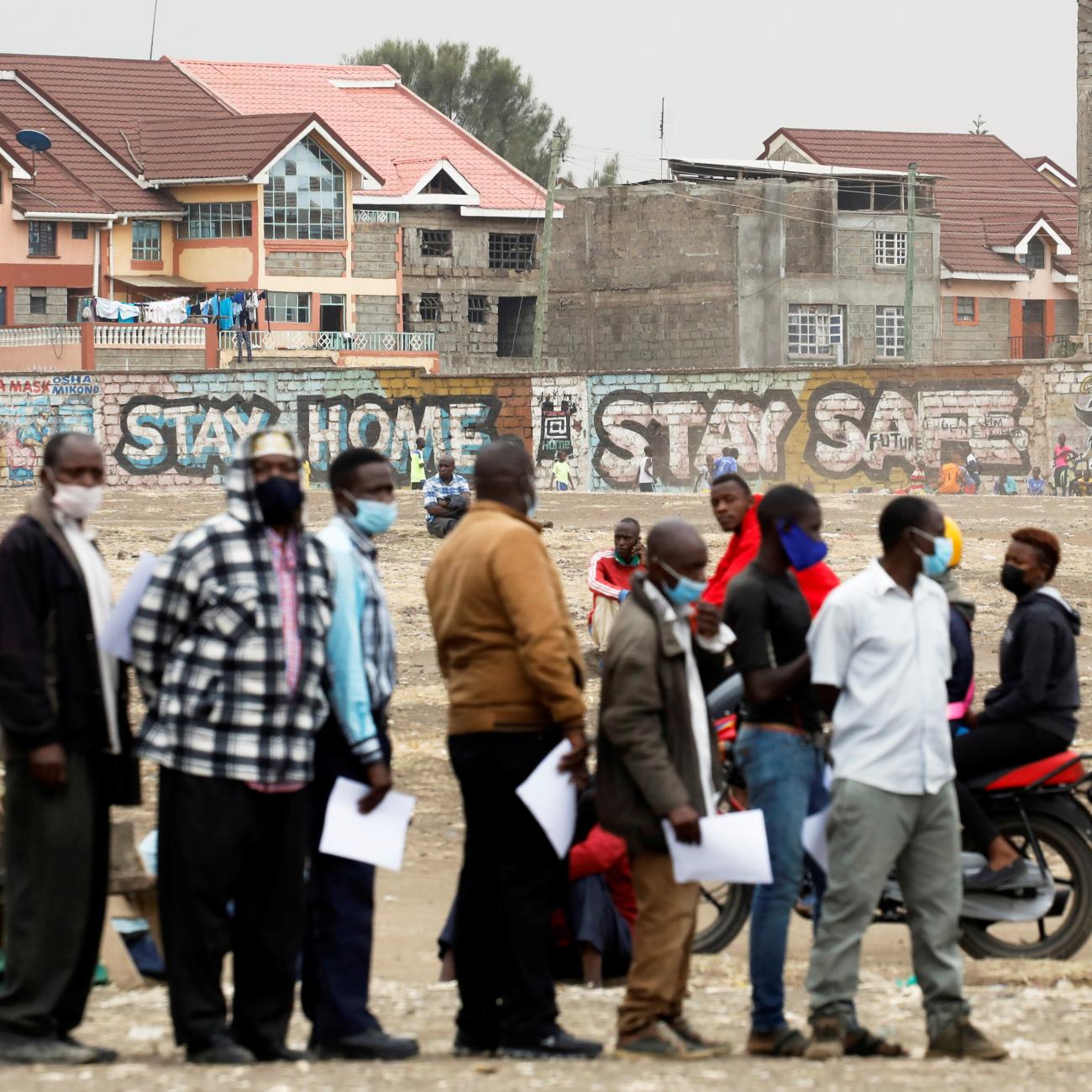 People wait in line to receive the AstraZeneca/Oxford COVID-19 vaccine, donated to Kenya by the UK government, in Nairobi, Kenya, August 8, 2021.