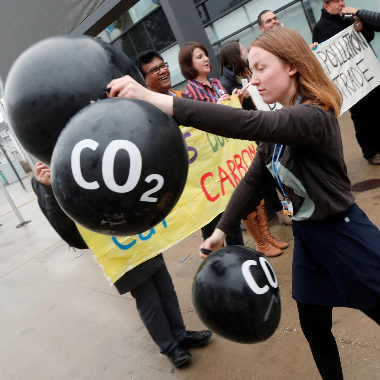 Activists protest against the carbon dioxide emissions trading in front of the World Congress Centre Bonn, the site of the COP23 U.N. Climate Change Conference, in Bonn