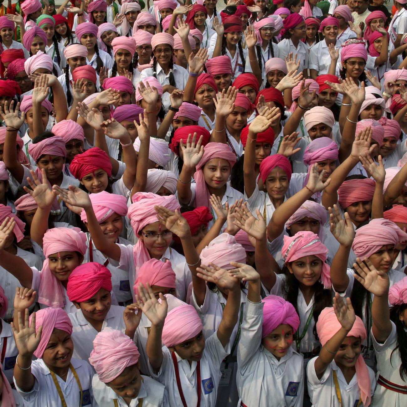 Girls wave as they take part in celebrations to mark the International Day of the Girl Child at a school in Chandigarh, India, on October 12, 2015. 