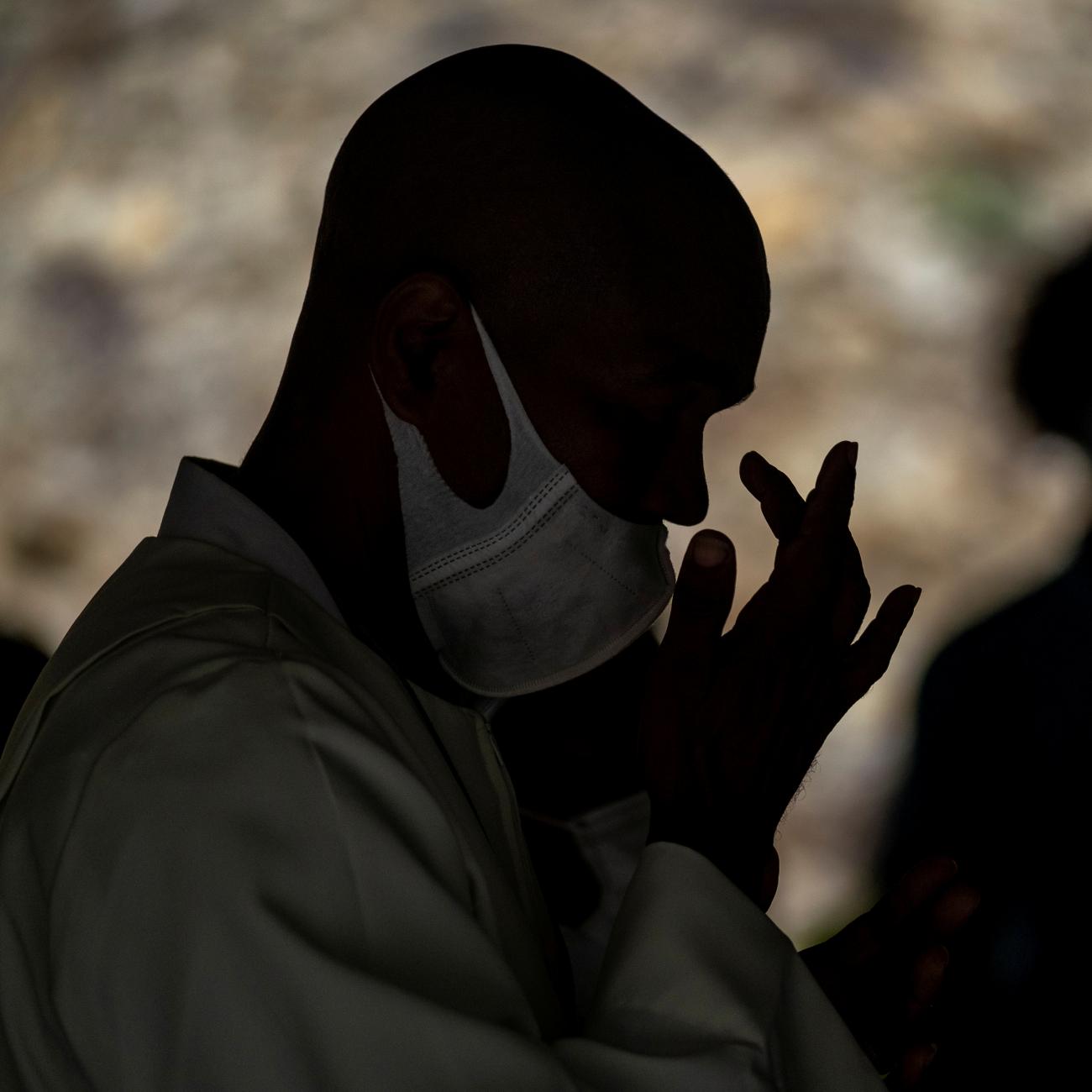 A church-goer crosses himself during Sunday mass at a structure next to the under renovation Saint Therese Catholic Church after unrest triggered by COVID-19 curbs, which have already rocked the nearby island of Guadeloupe, in Fort-de-France, Martinique November 28, 2021