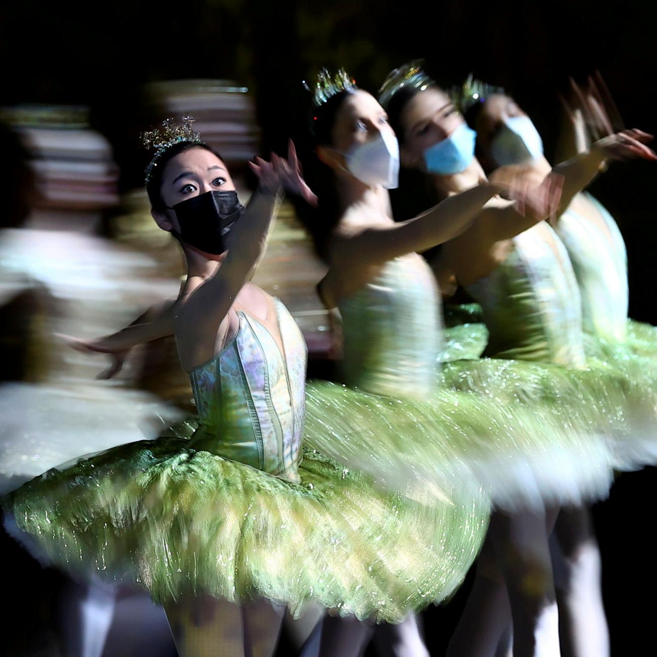 Dancers with the Berlin State Ballet (Staatsballett Berlin) wear face masks during a dress rehearsal of Don Quixote at Deutsche Oper Berlin, in Germany, on December 1, 2021.