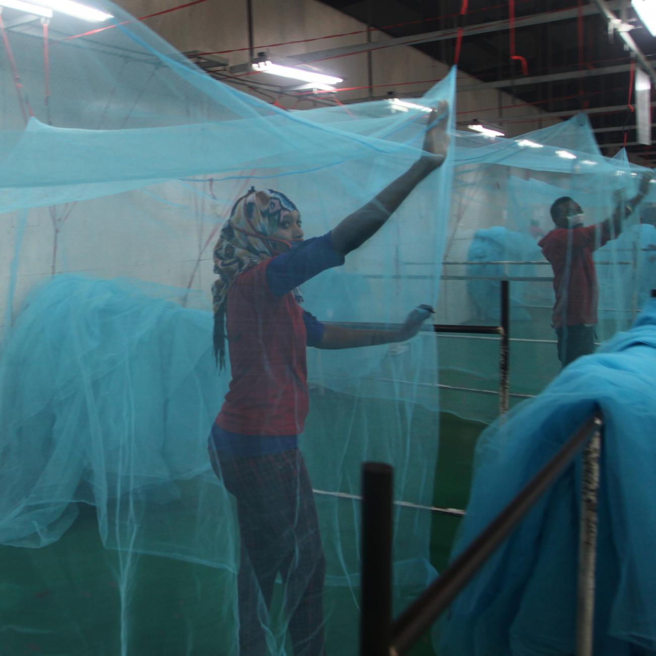 Employees look for holes in mosquito netting at the A to Z Textile Mills factory where insecticide-treated bed nets are produced, in Arusha, Tanzania, on May 10, 2016.