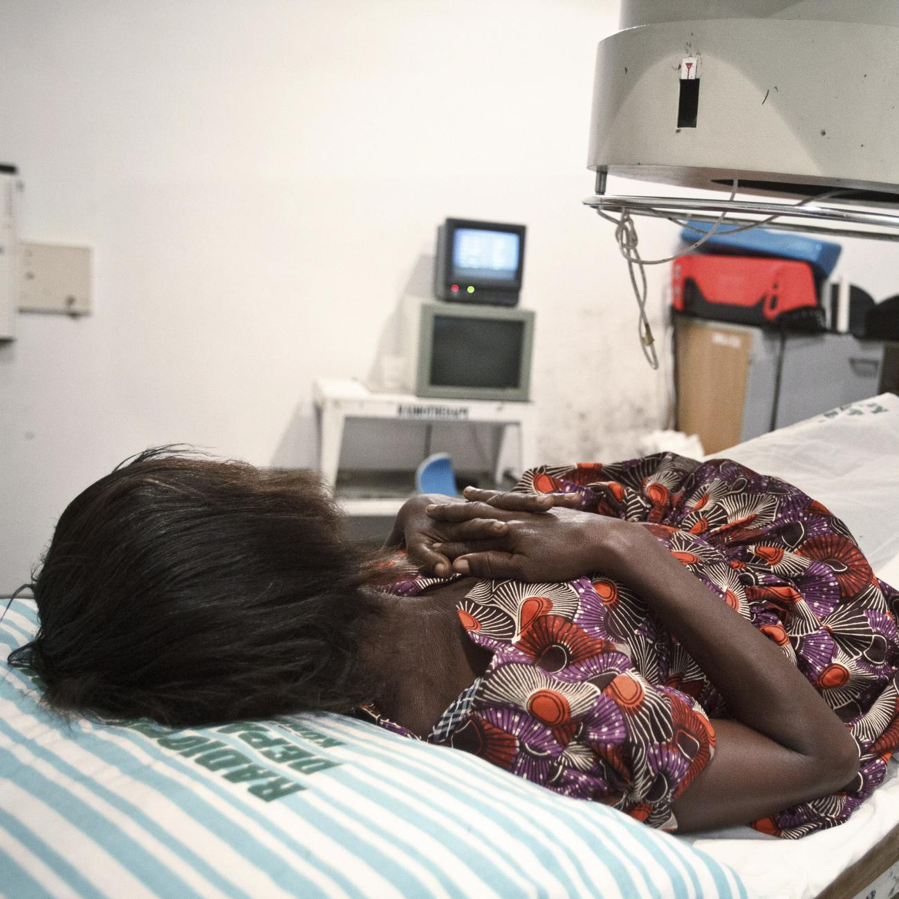 A 52-year-old woman suffering from bladder cancer lies under a radiotherapy simulator used to pinpoint areas to treat at the Korle Bu Teaching Hospital in Accra April 24, 2012.