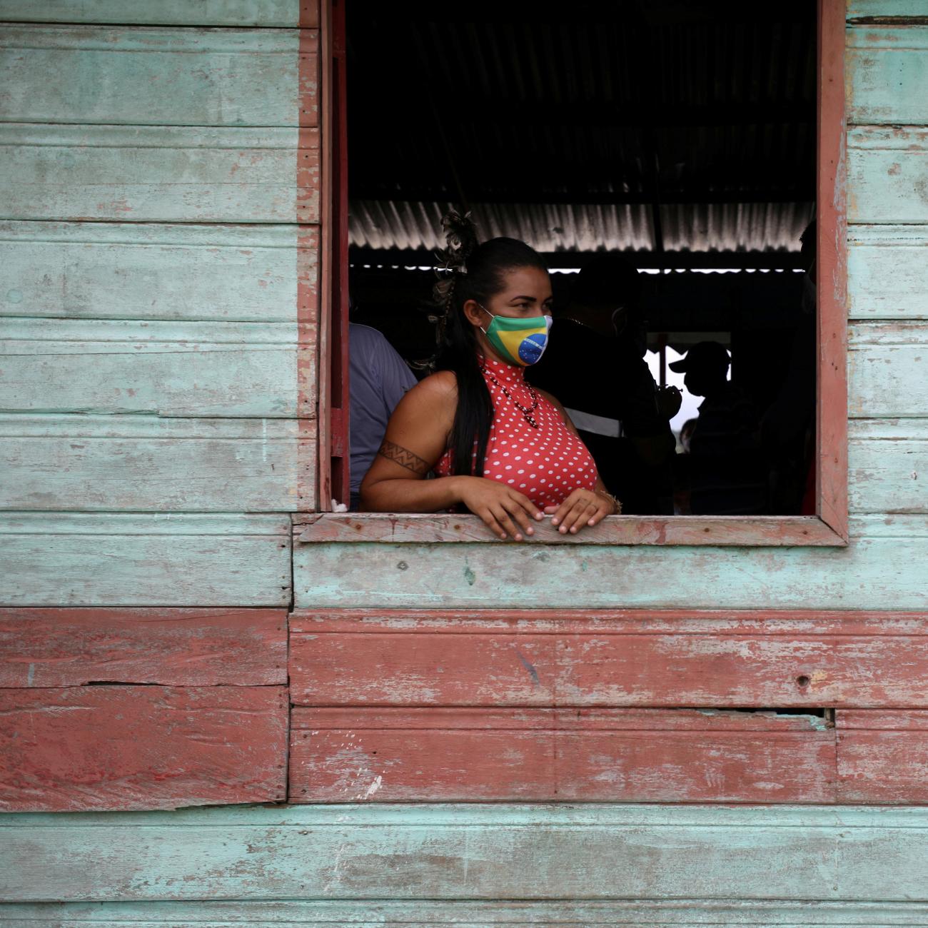 An Indigenous woman waits to receive the Sinovac's CoronaVac coronavirus disease (COVID-19) vaccine at Sao Jose Village in the Indigenous land Rio Urubu from the ethnicity Mura in the Urubu river banks in Itacoatiara, Amazonas state, Brazil, February 13, 2021. Photo by REUTERS/Bruno Kelly