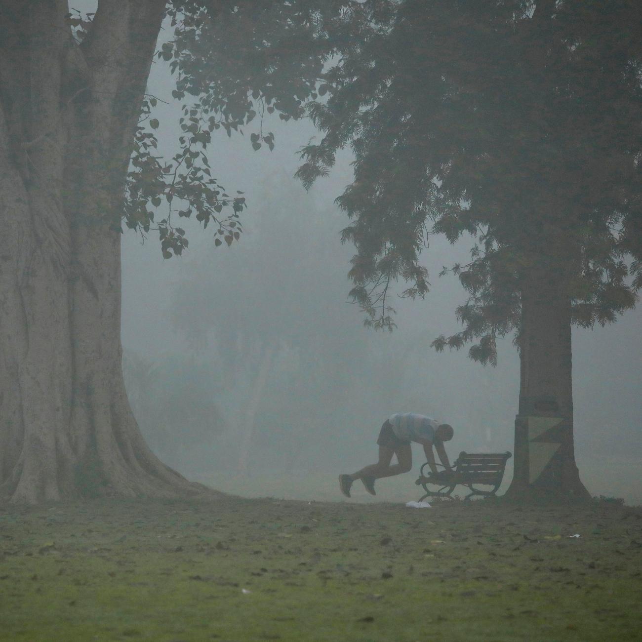 A man exercises in a park on a smoggy morning in New Delhi, India, on November 9, 2017.