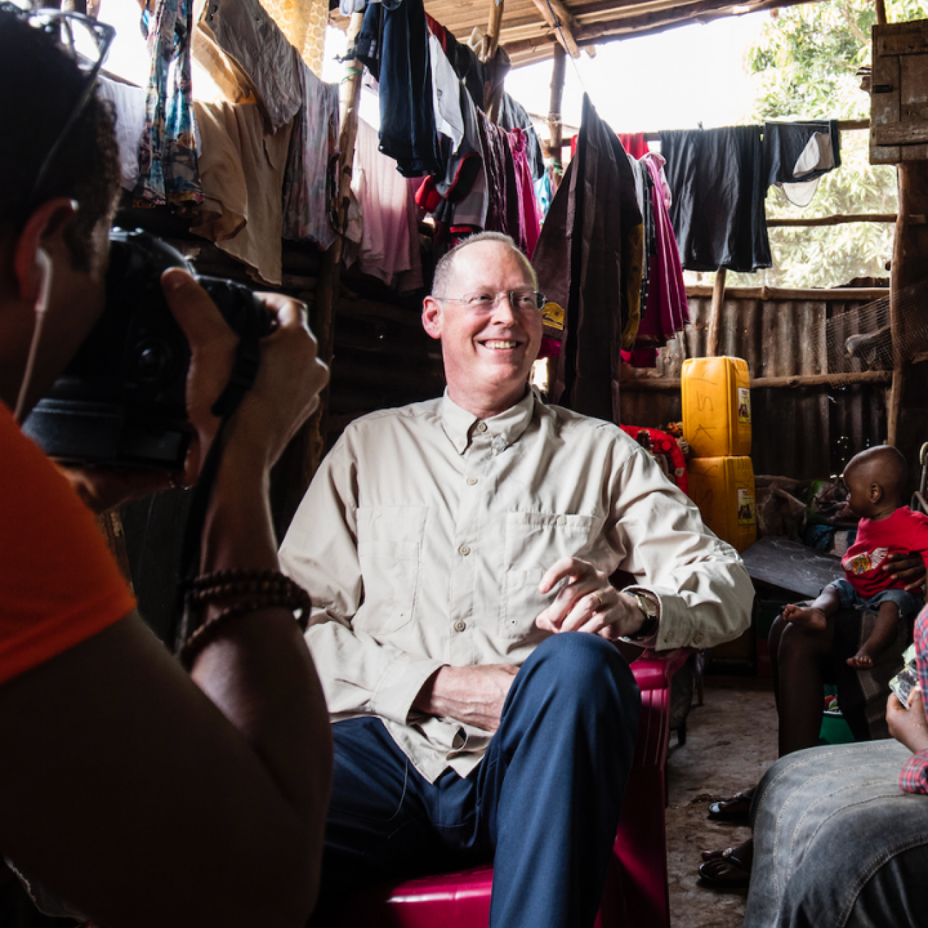 Paul Farmer visits Ebola survivor Yabom Koroma and her family at their home in the Mountain Court section of Freetown, Sierra Leone on December 14, 2015. Photo courtesy of PIH.