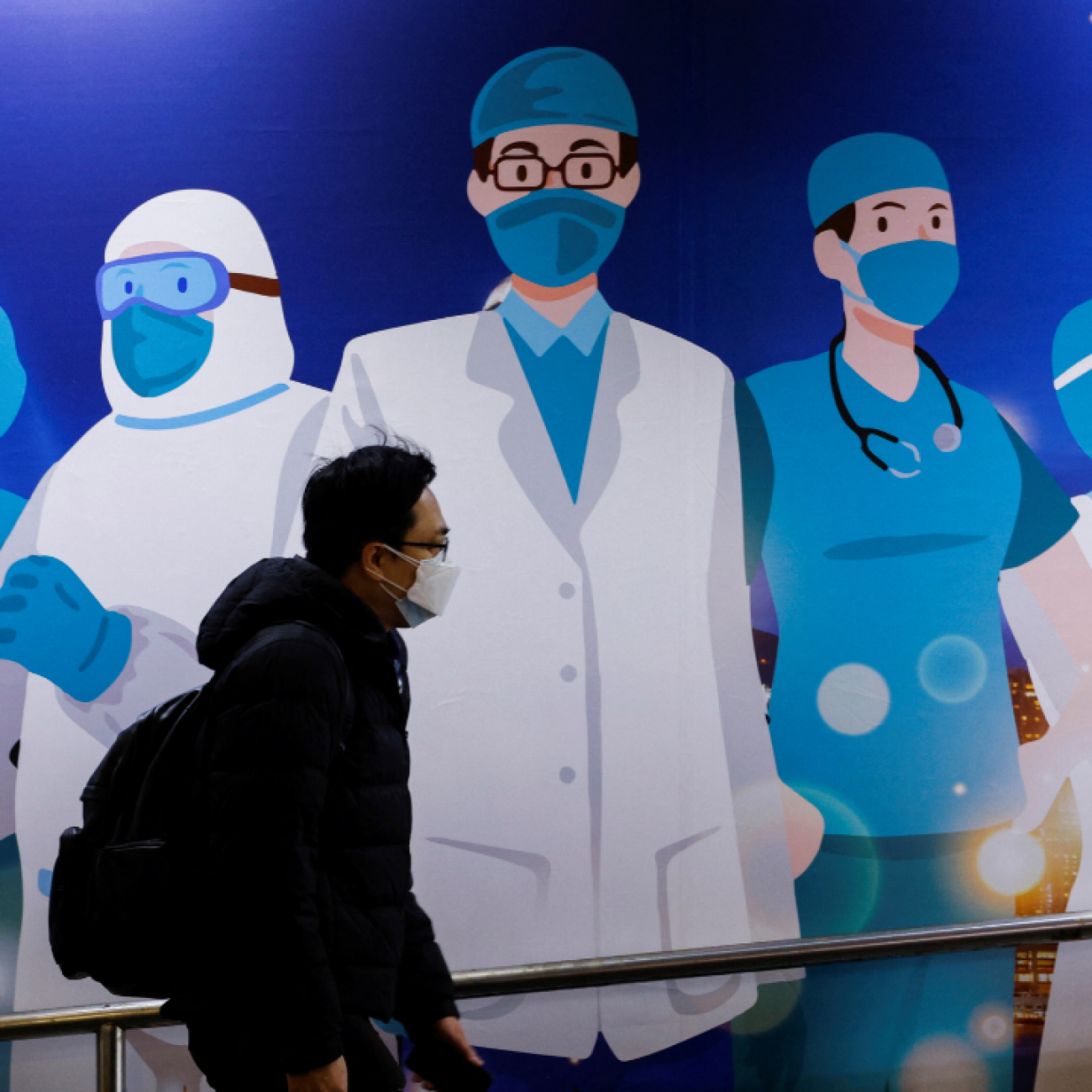 A man walks past street art supporting medical professionals during the COVID-19 outbreak in Hong Kong on February 24, 2022. Photo by REUTERS/Tyrone Siu