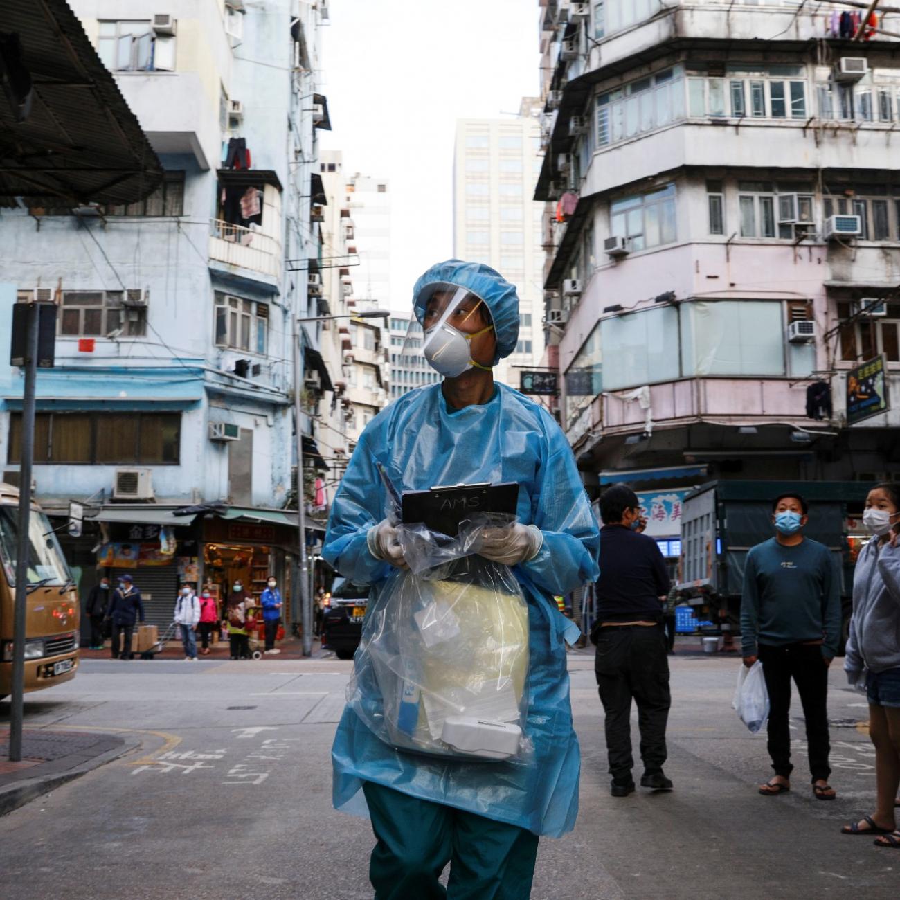 A medical worker in a protective suit walks near the residential area at Jordan, after the expand of mandatory coronavirus disease (COVID-19) testing, in Hong Kong, China January 19, 2021