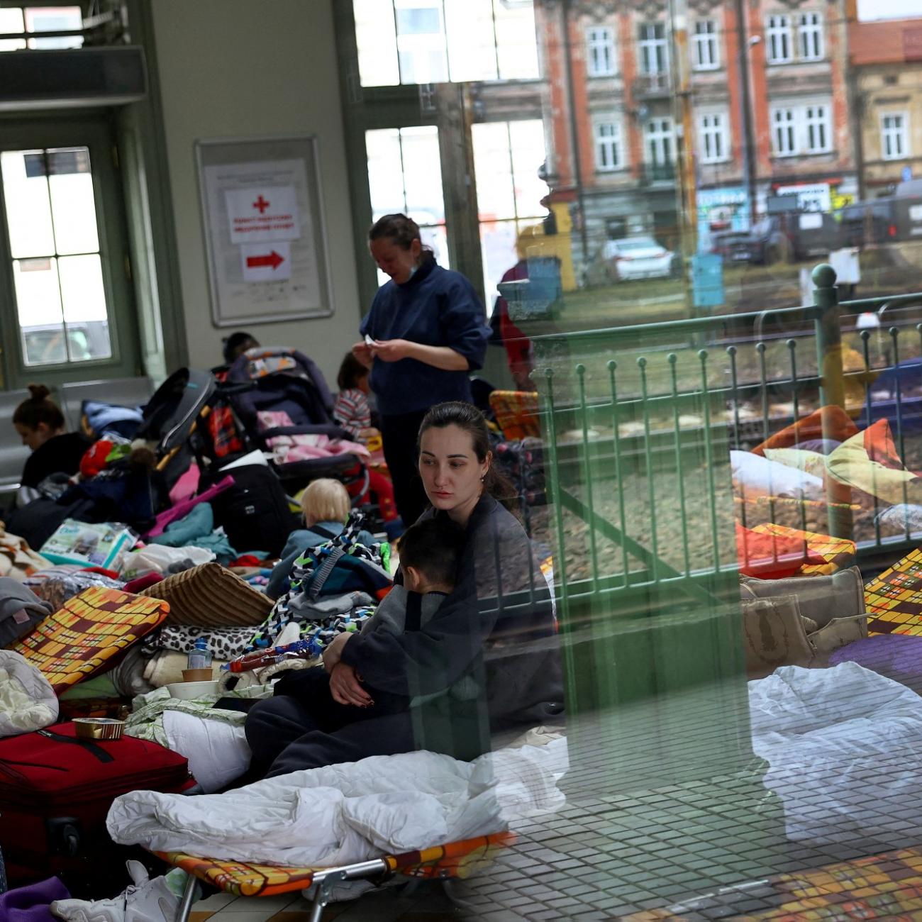 Refugees who fled from the Russian invasion in Ukraine rest inside a temporary camp at the train station in Przemysl, Poland, March 2, 2022.