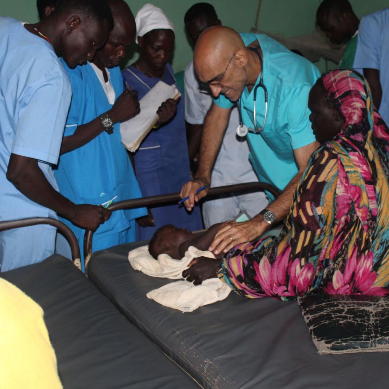 Dr. Tom Catena tends to a patient, at Mother of Mercy hospital, in Sudan.