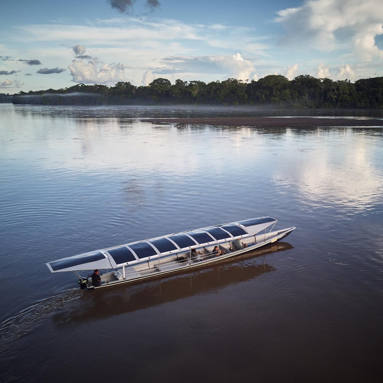 Sunkirum, a solar-powered canoe, sails on the Pastaza River in the Amazon in Ecuador, where the Achuar Indigenous people have lived for thousands of years.