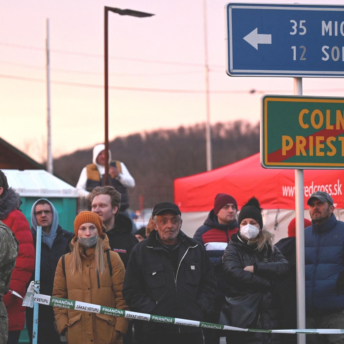 People wait at the Ukrainian border in Vysne Nemecke, Slovakia, after Russia launched a massive military operation against Ukraine