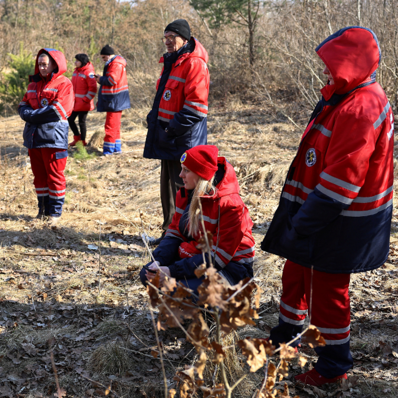 Ukrainian paramedics take cover in the woods as air raid sirens go off again following an attack on the Yavoriv military base, outside a hospital in Yavoriv, Ukraine, during Russia’s invasion of Ukraine, on March 13, 2022. 