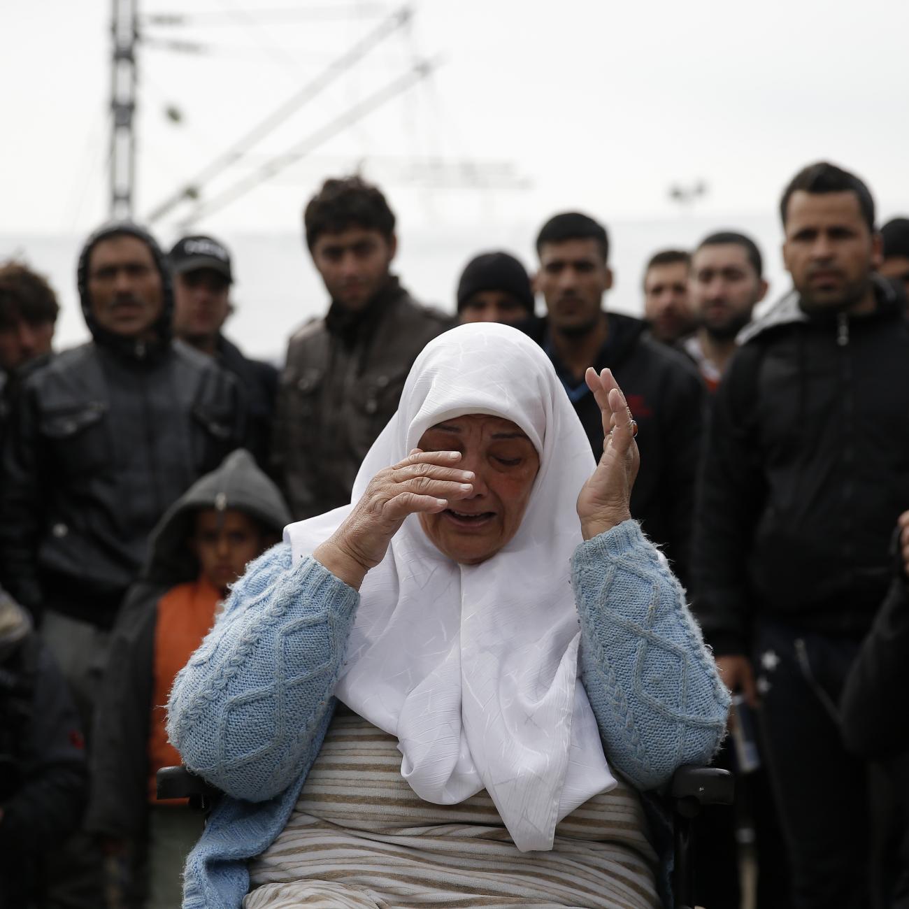 A displaced woman in a wheelchair cries during a protest at a makeshift camp at the Greek-Macedonian border near the village of Idomeni, Greece, on March 27, 2016.