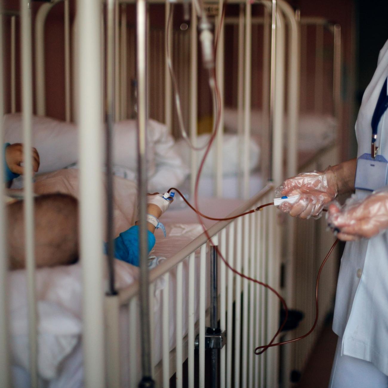 a nurse tends to a child with cancer