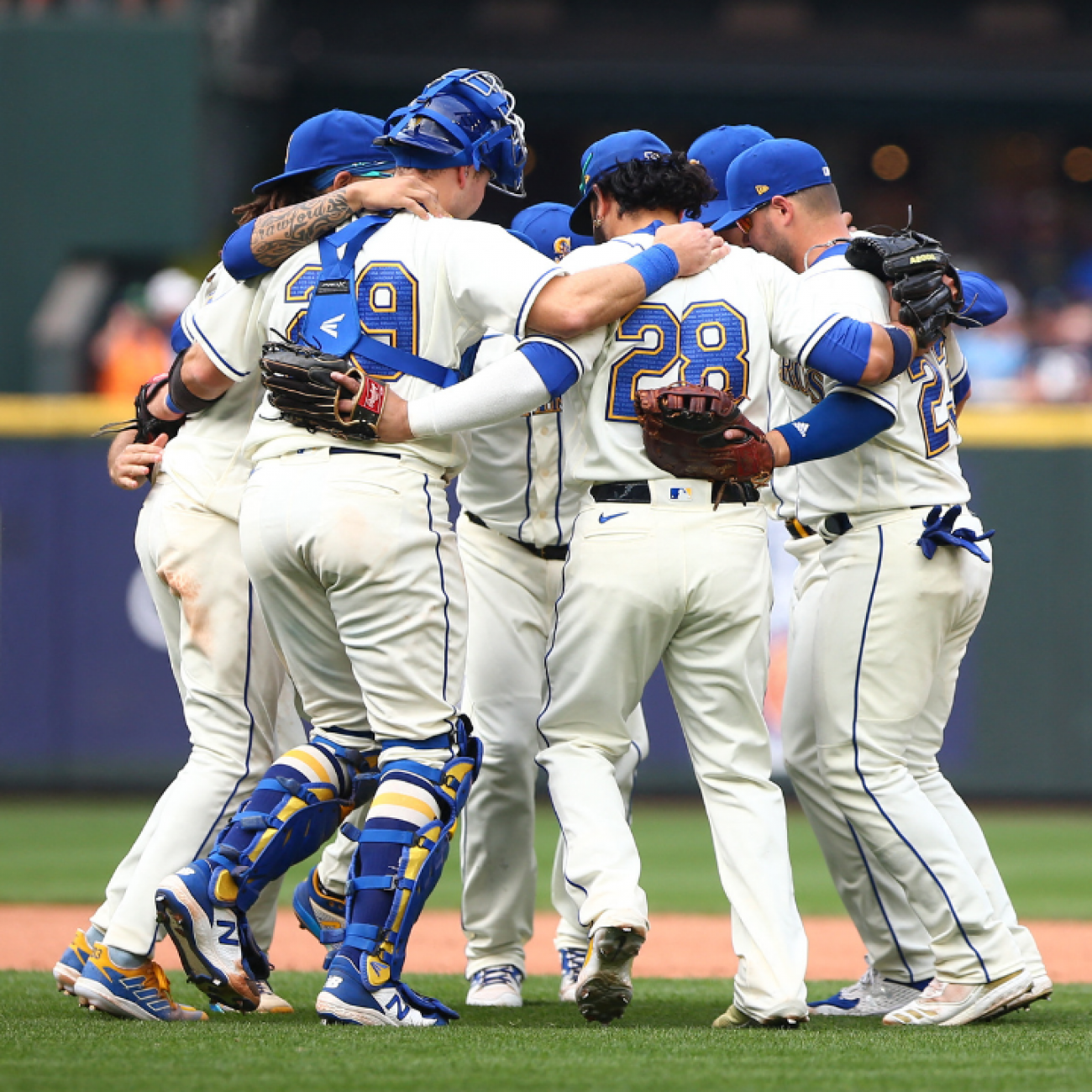 Seattle Mariners infielders hug and dance as they celebrate beating the San Diego Padres 6-1, at T-Mobile Park, in Seattle, Washington, on September 14, 2022.