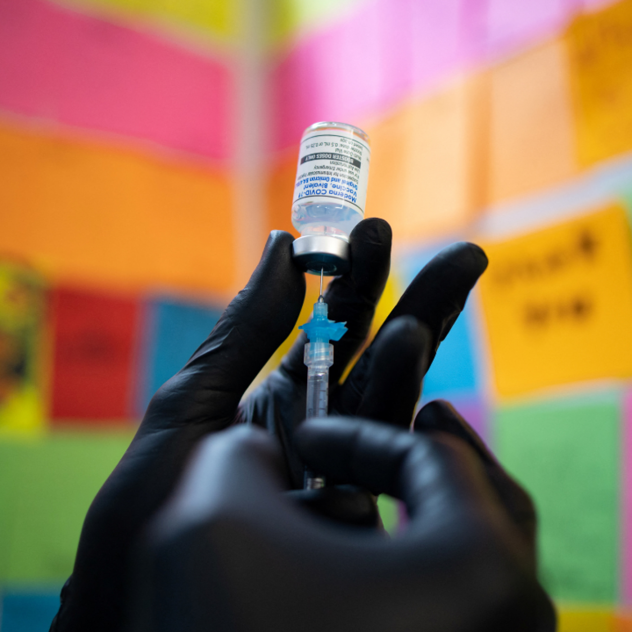 A close-up photo of a hand in a black medical glove shows Dr. Mayank Amin preparing a Moderna COVID booster vaccine targeting BA.4 and BA.5 omicron subvariants, at Skippack Pharmacy in Schwenksville, Pennsylvania, September 8, 2022. 