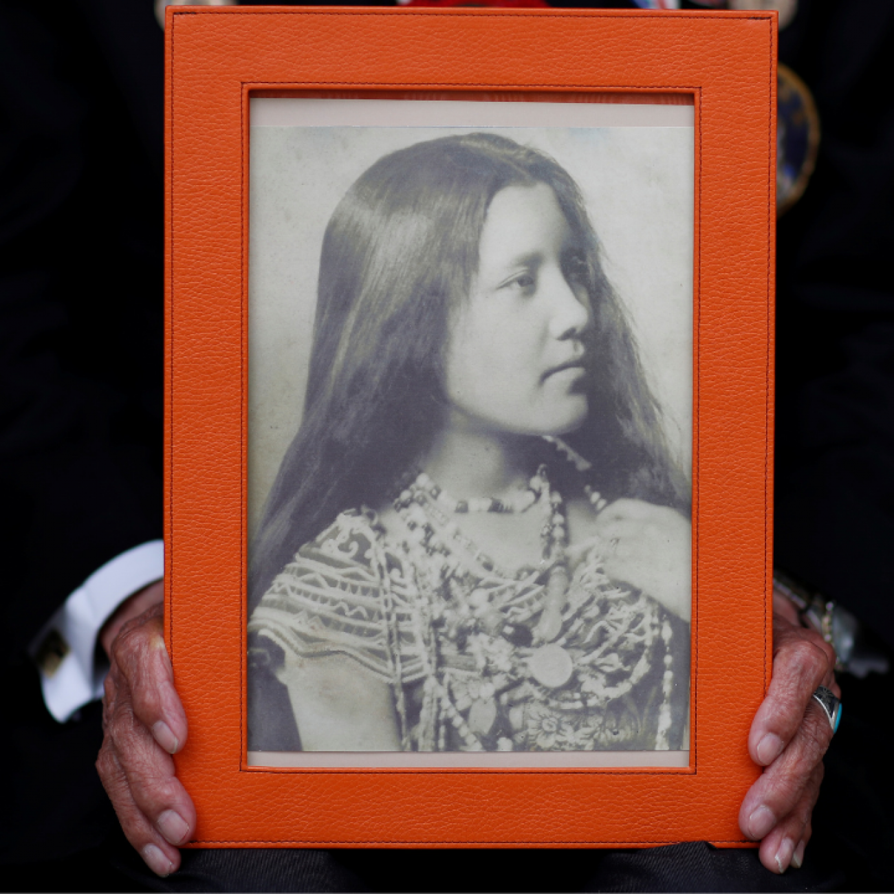 A close-up of the hands of Charles Norman Shay, a member of the Penobscot Nation and a World War II veteran, holding a picture of his mother Florence. Photo taken in Bretteville l'Orgueilleuse, France, on May 18, 2019. 