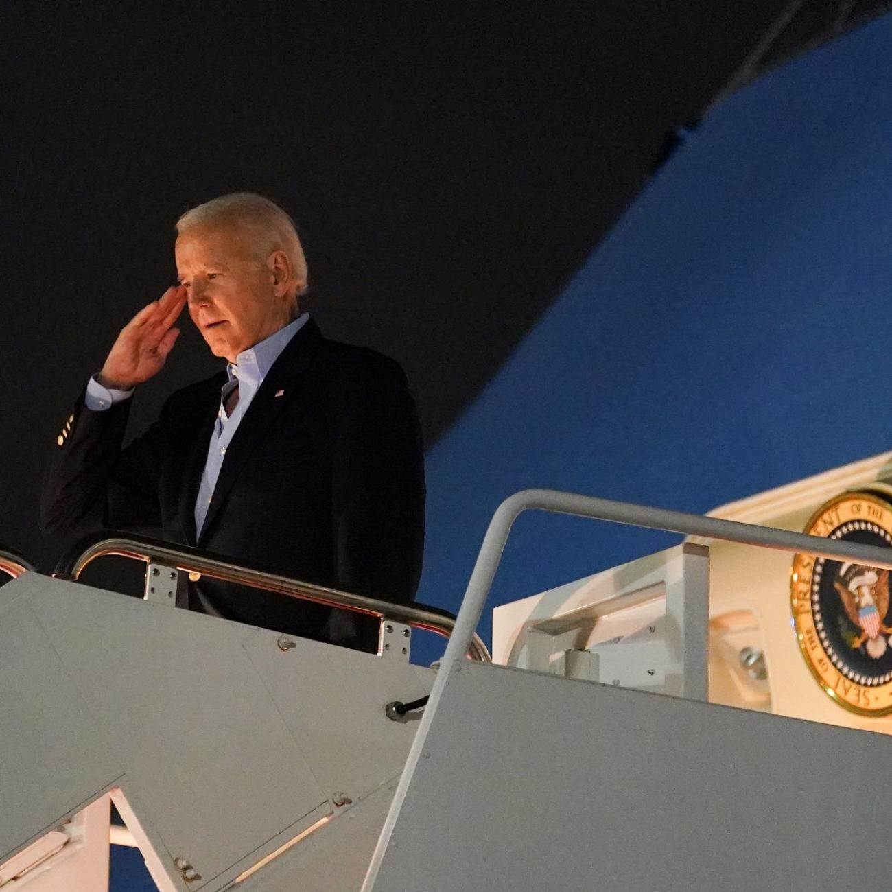 U.S. President Joe Biden salutes from Air Force One as he departs for Egypt to attend the COP27 summit from Joint Base Andrews in Maryland, on November 10, 2022.