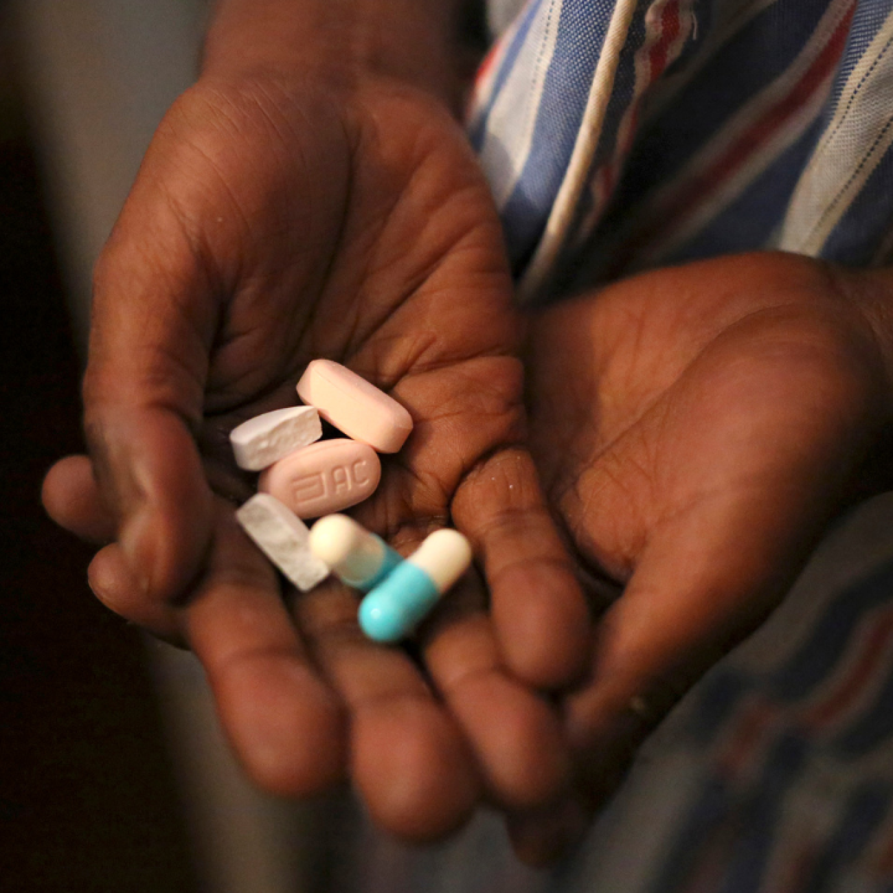 A close-upu image of a nine-year-old boy's hands holding antiretroviral (ARV) pills prescribed for HIV infection at Nkosi's Haven, in Johannesburg, South Africa.