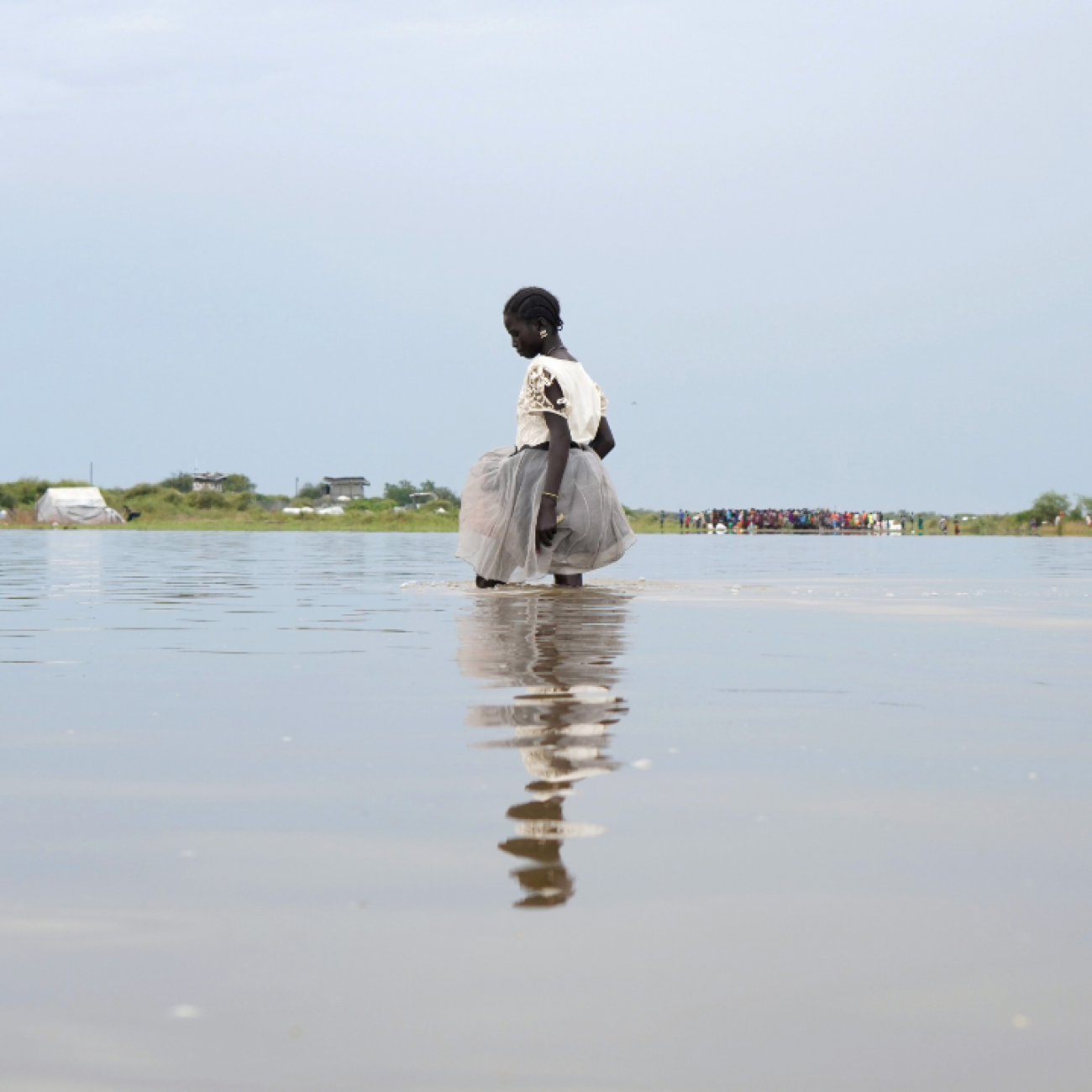 A girl dressed in white walks knee-deep in water after heavy rains and floods in the town of Pibor, Boma state, South Sudan, on November 6, 2019.