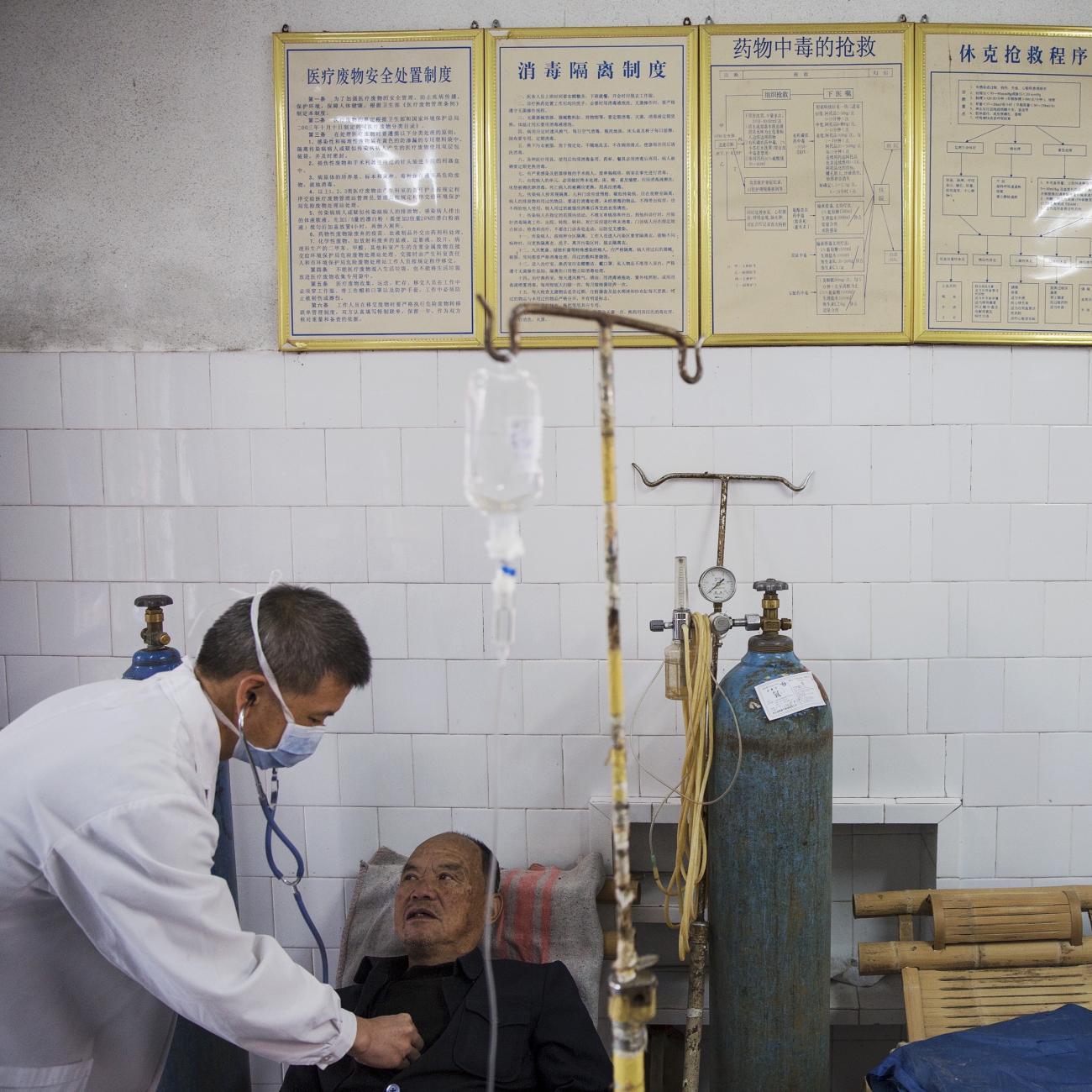 A doctor checks a patient in the hospital in Wuyi County, Zhejiang Province, China, on October 19, 2015. REUTERS/Damir Sagolj