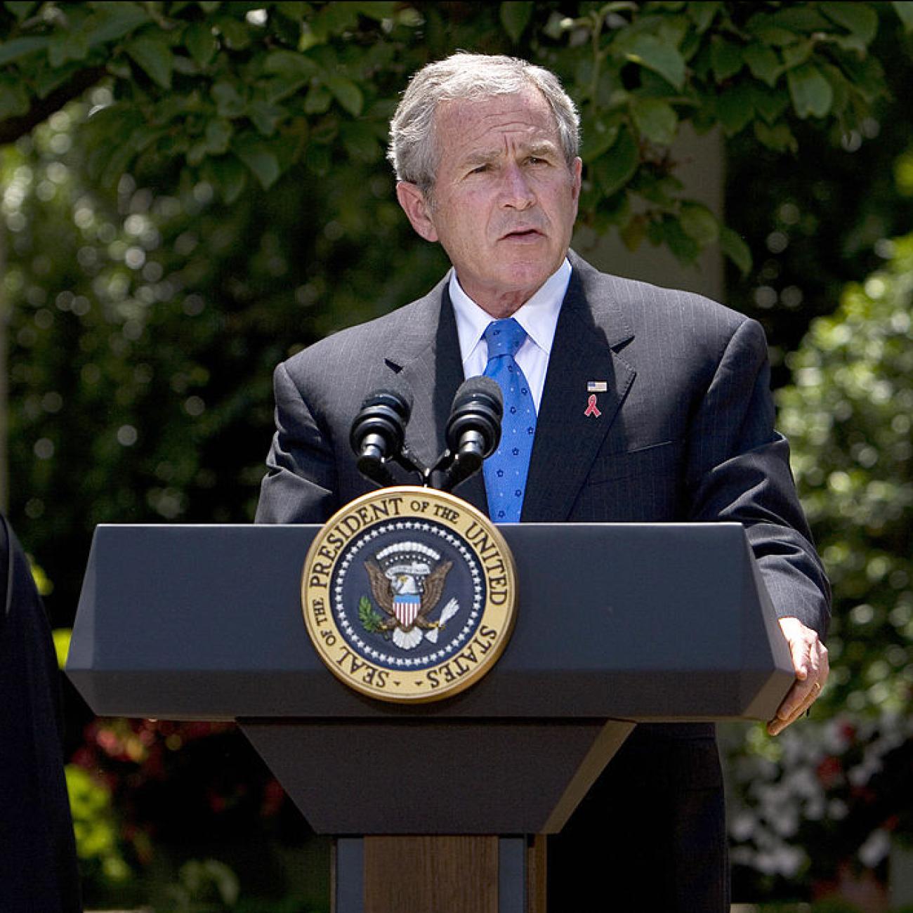 US President George W. Bush speaks on the President's Emergency Plan for AIDS Relief as Bishop Paul Yowakim looks on 30 May 2007 in the Rose Garden of the White House in Washington, DC.