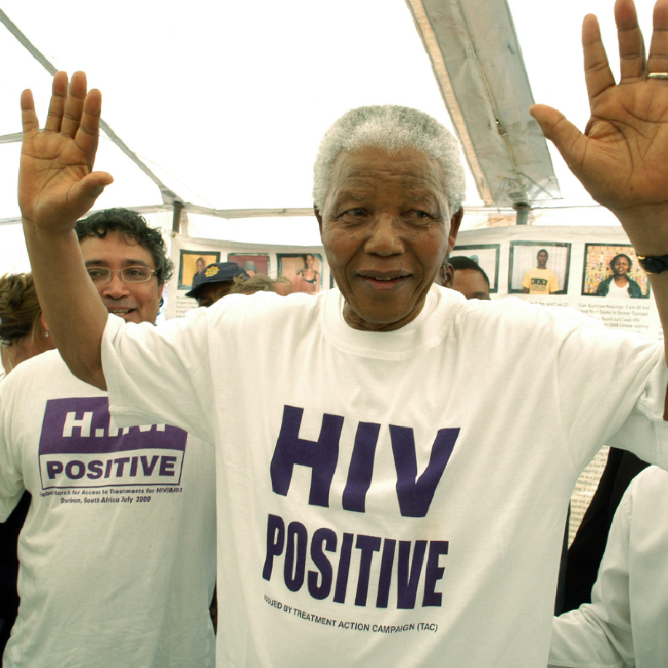 Former president of South Africa Nelson Mandela—wearing a white t-shirt with HIV POSITIVE in purple printed on the front—visits the township of Khayelitsha in Western Cape, South Africa. Photo by Media24/Gallo Images/Getty Images