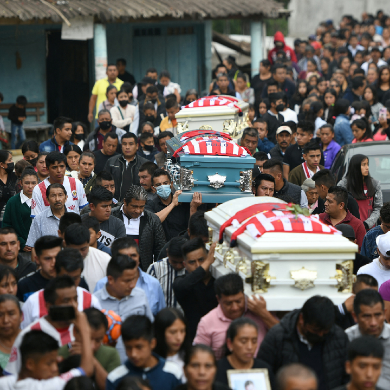 Relatives and friends carry the caskets of Jair Valencia, 19, Yovani Valencia, 16, and Misael Olivares, 16, at their funeral in San Marcos Atexquilapan, in Veracruz, Mexico, on July 15, 2022. They died in a human trafficker’s truck, in Texas, in June 2022.