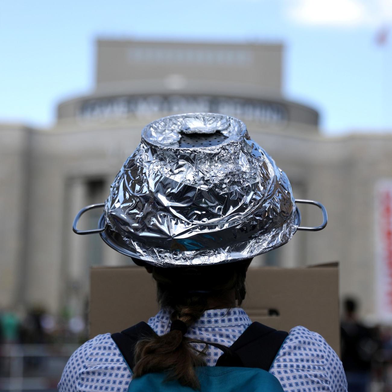 A woman attends a protest of conspiracy theorists and other demonstrators at Rosa Luxemburg Platz, amid the spread of COVID-19, in Berlin, Germany, on May 9, 2020.