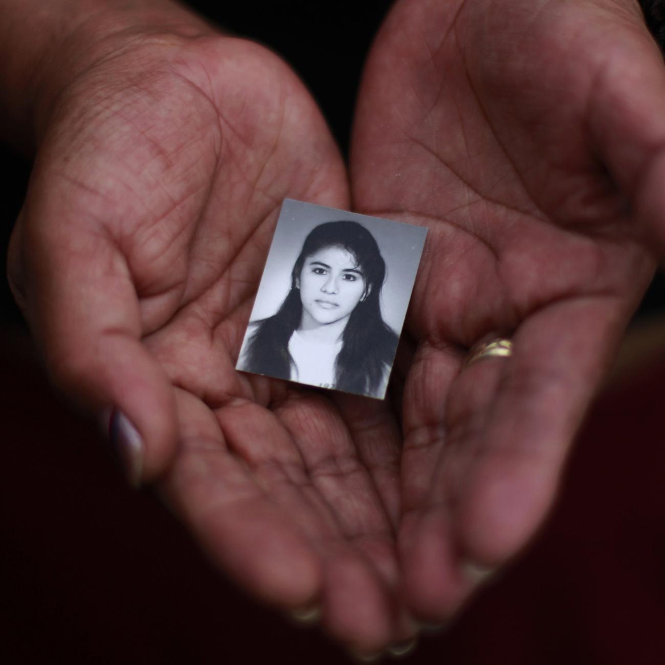 A family member holds a photograph of Rosivel Elisabeth Grande in Quezaltepeque, Honduras, on July 2, 2013. Grande was killed by an unidentified man who shot her five times when she was going to work 